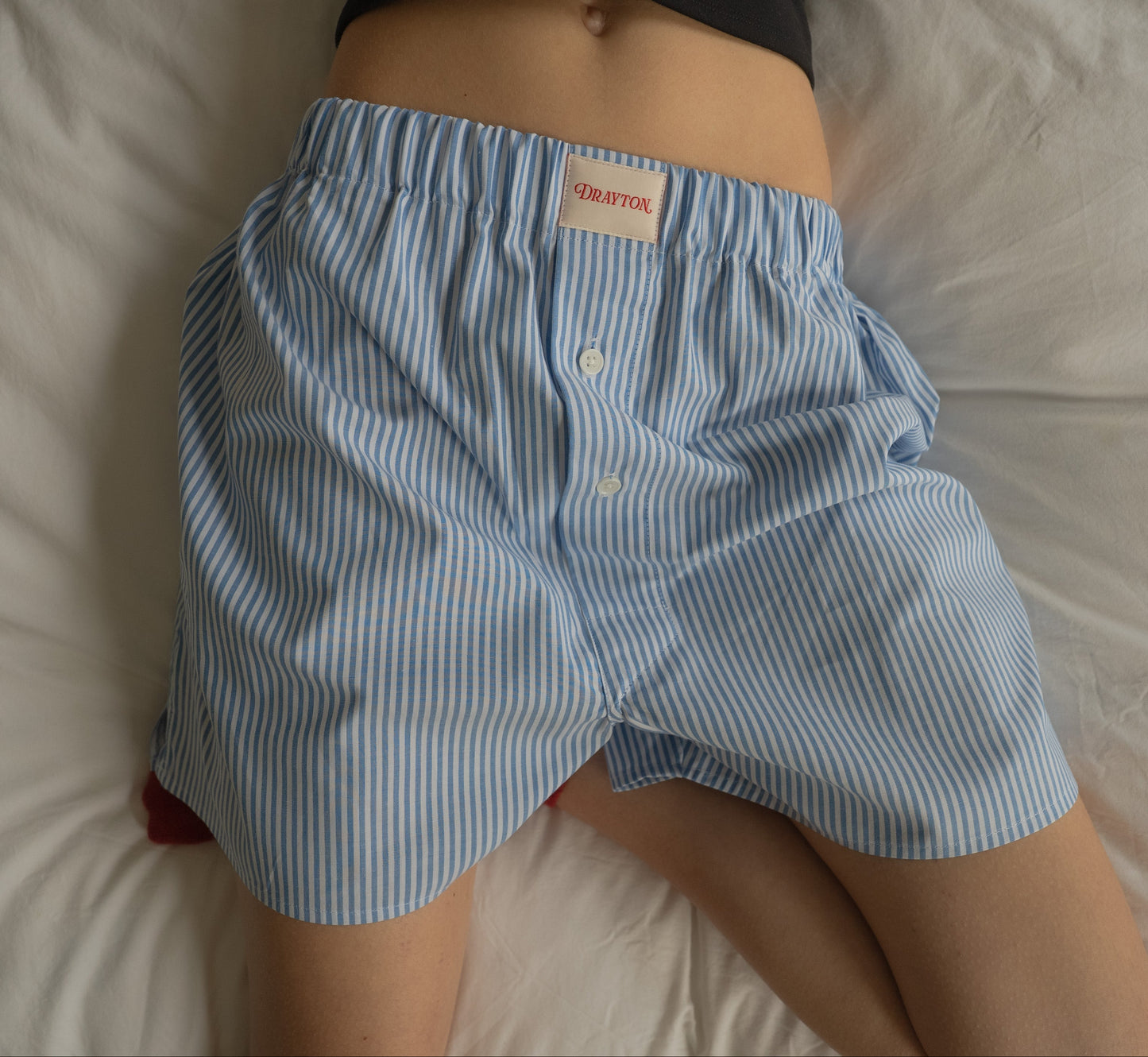 Light blue striped boxer shorts with a brand label on a white background